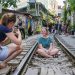 Tourists still take photos at the train station cafe street in Hanoi