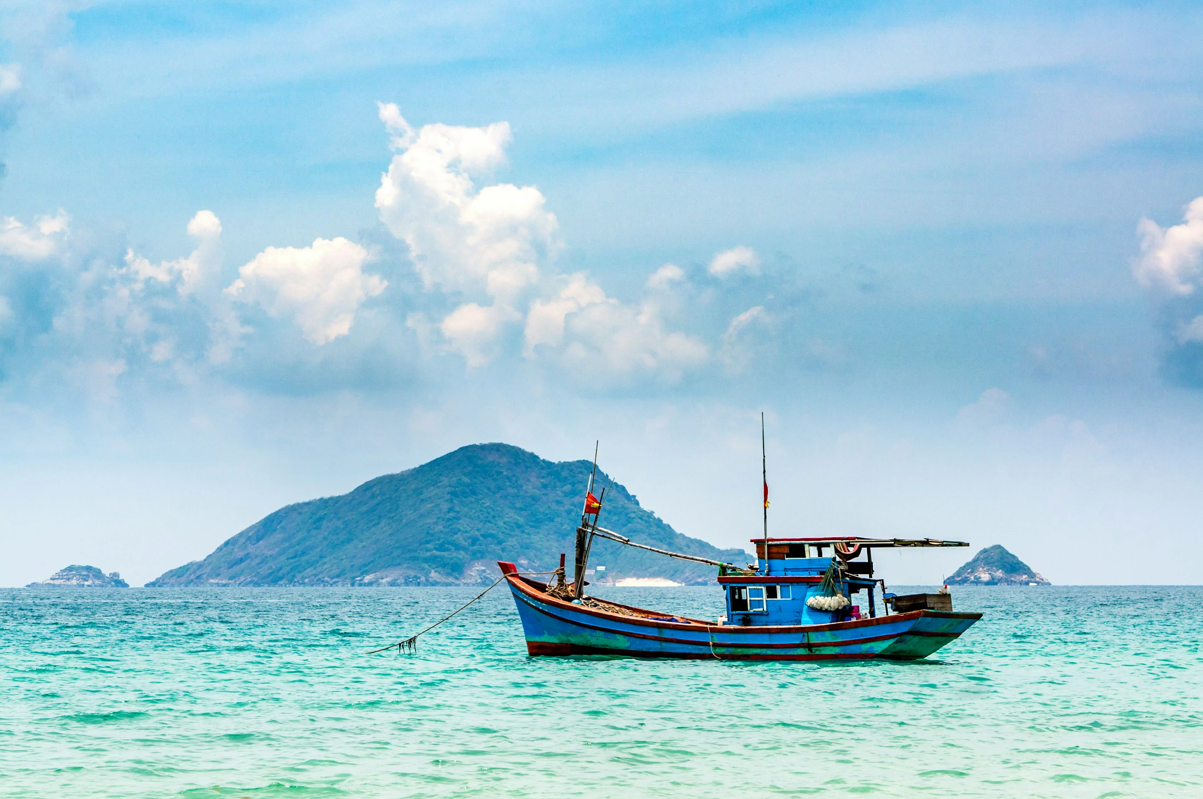 A fishing boat floating in blue waters off the Con Dao Islands